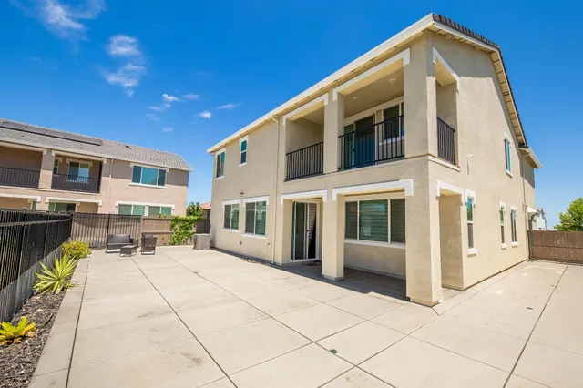 an aerial view of a tennis ground and a cars park side of the road