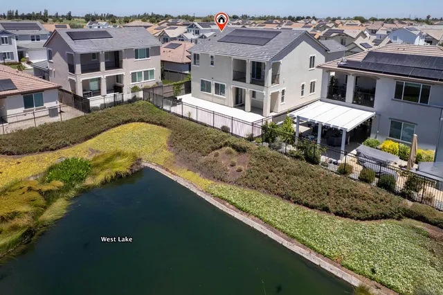 a view of a house with backyard and a patio