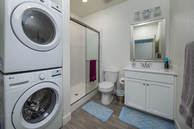 a kitchen with a refrigerator sink and cabinets