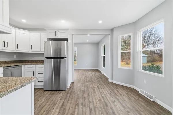 a kitchen with a refrigerator and a stove top oven
