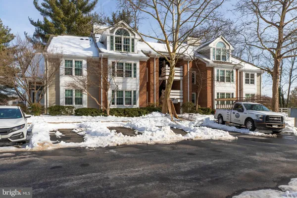 a view of a building with a yard covered in snow