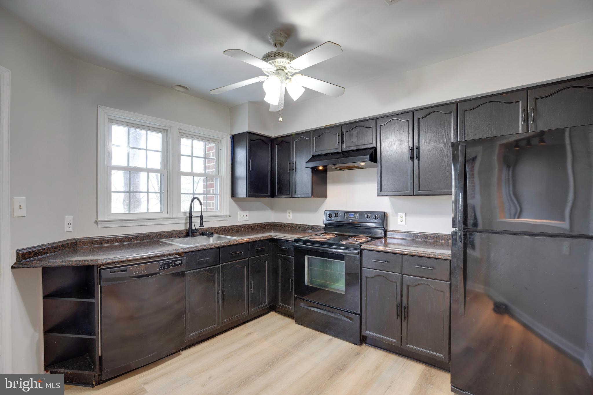 11172 Beaver Trail Court Reston, VA 20191 - Photo 11 of 26 a kitchen with stainless steel appliances granite countertop a sink stove and refrigerator