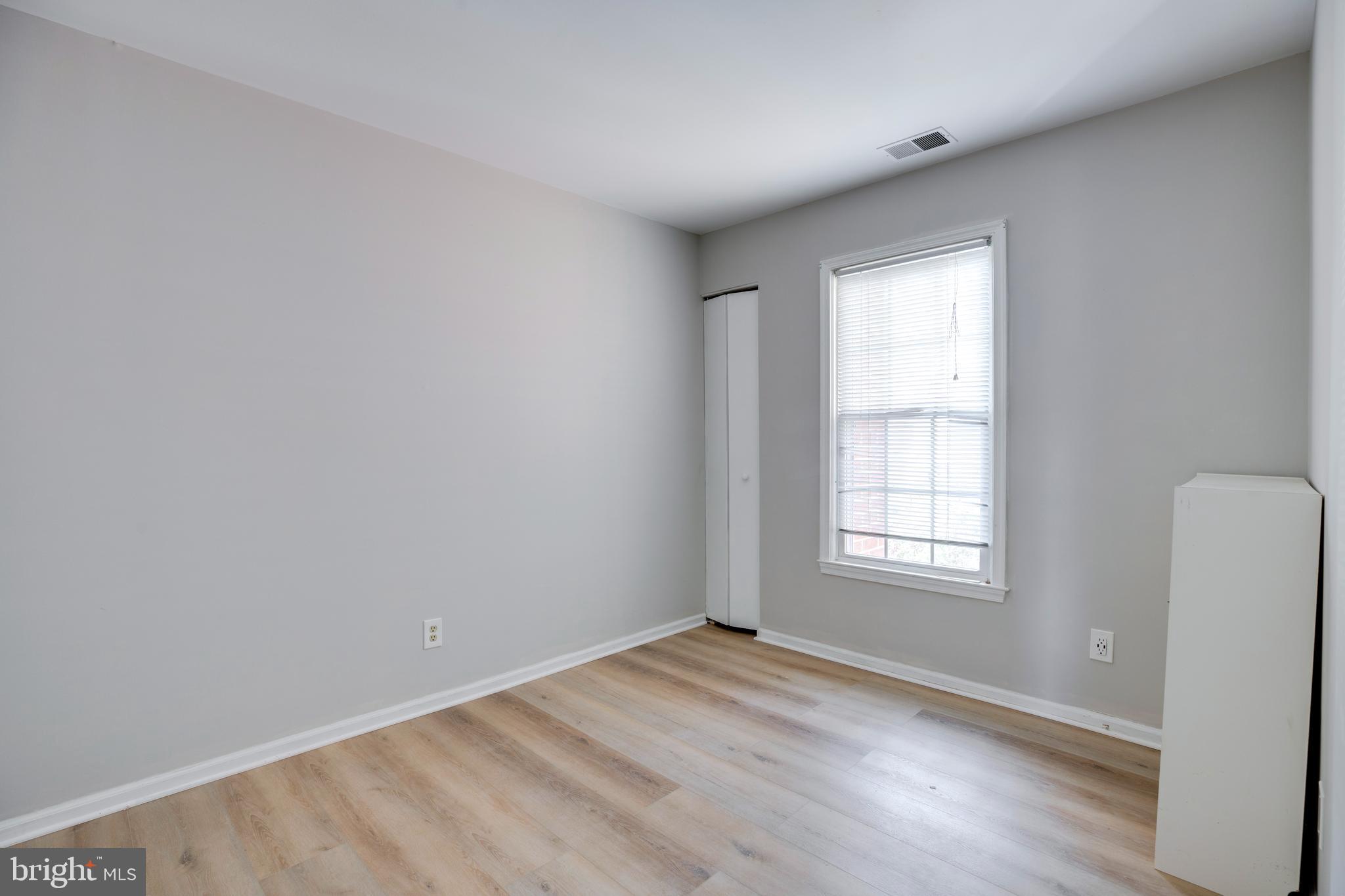 11172 Beaver Trail Court Reston, VA 20191 - Photo 16 of 26 an empty room with wooden floor and windows