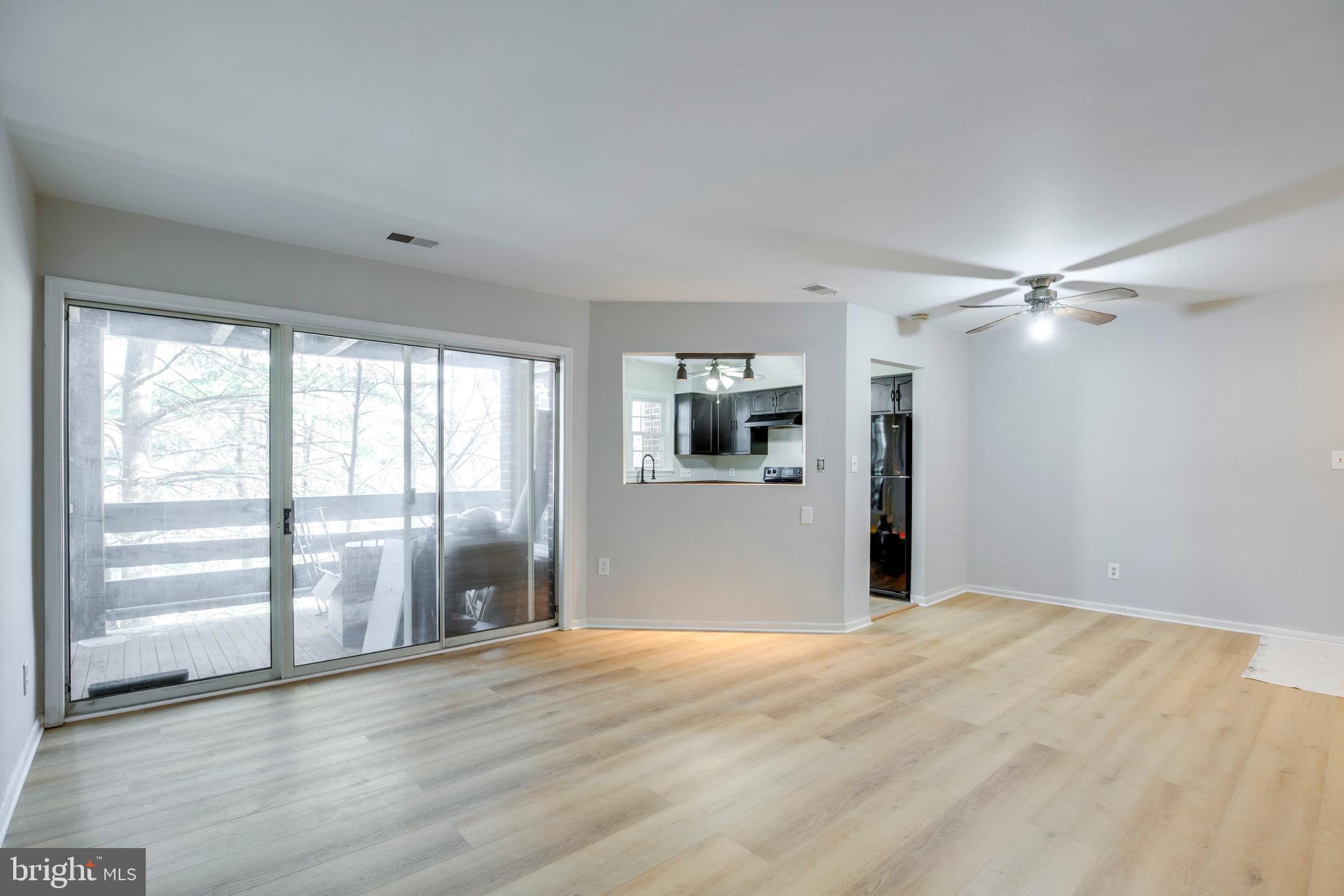 11172 Beaver Trail Court Reston, VA 20191 - Photo 3 of 26 a view of empty room with wooden floor and fan