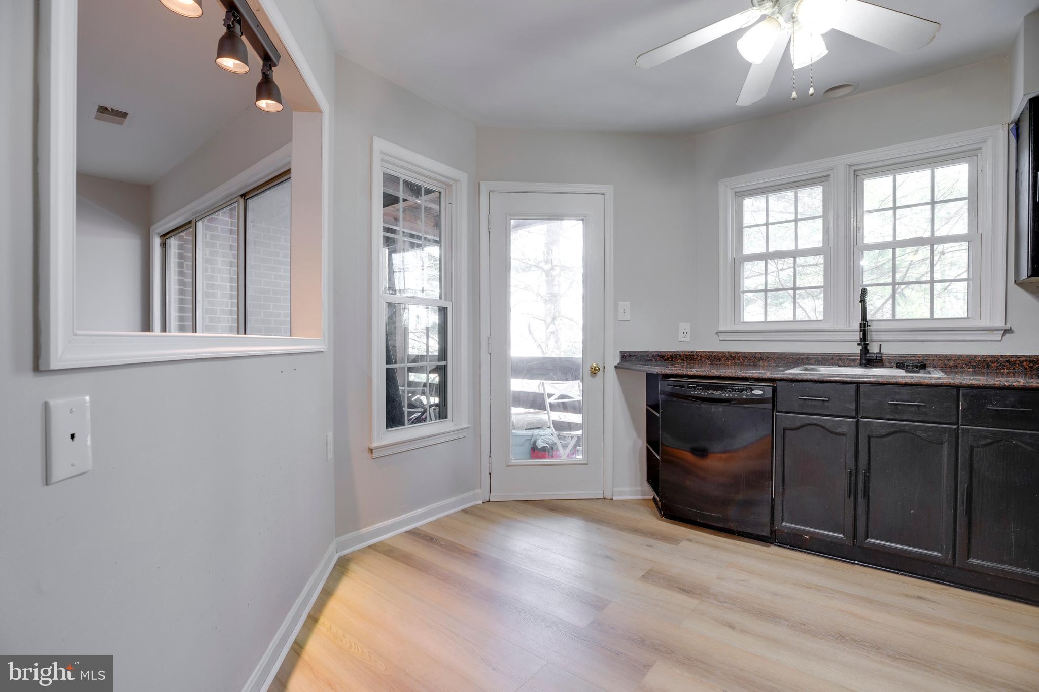 11172 Beaver Trail Court Reston, VA 20191 - Photo 9 of 26 a spacious bathroom with a granite countertop sink and dishwasher with wooden floor