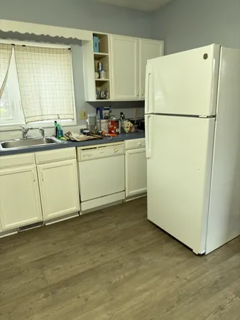 a kitchen with a refrigerator sink stove and cabinets