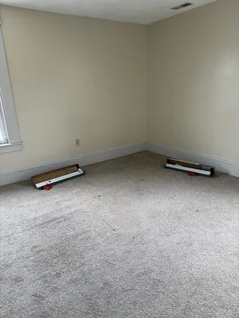 an empty room with a exposed radiator