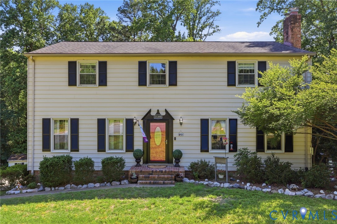 11200 Surry Road Chester, VA 23831 - Photo 1 of 48 a front view of a house with garden