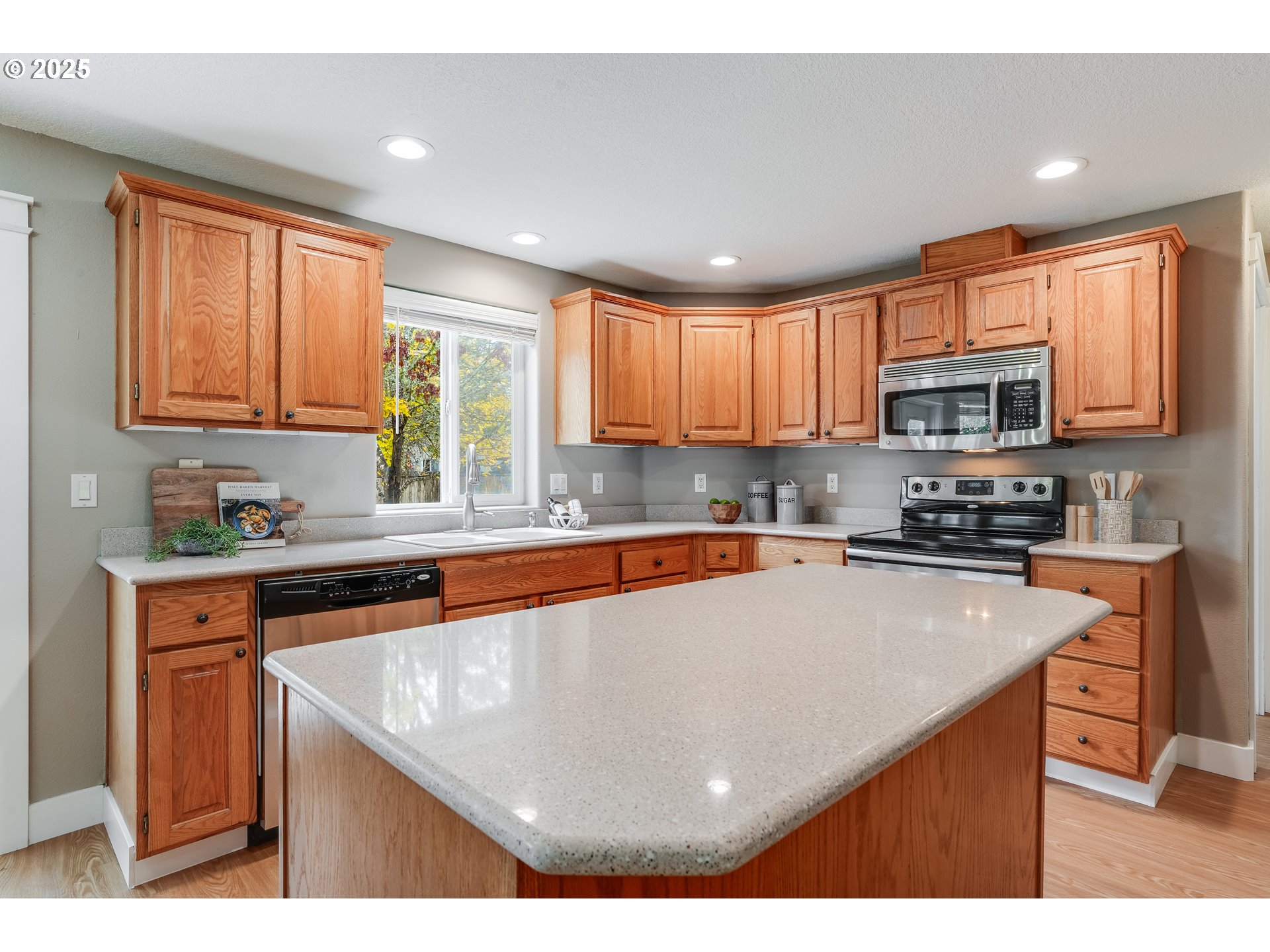 1224 Alyssum Avenue Forest Grove, OR 97116 - Photo 13 of 39 a kitchen with stainless steel appliances granite countertop a stove a sink dishwasher and a microwave with wooden cabinets