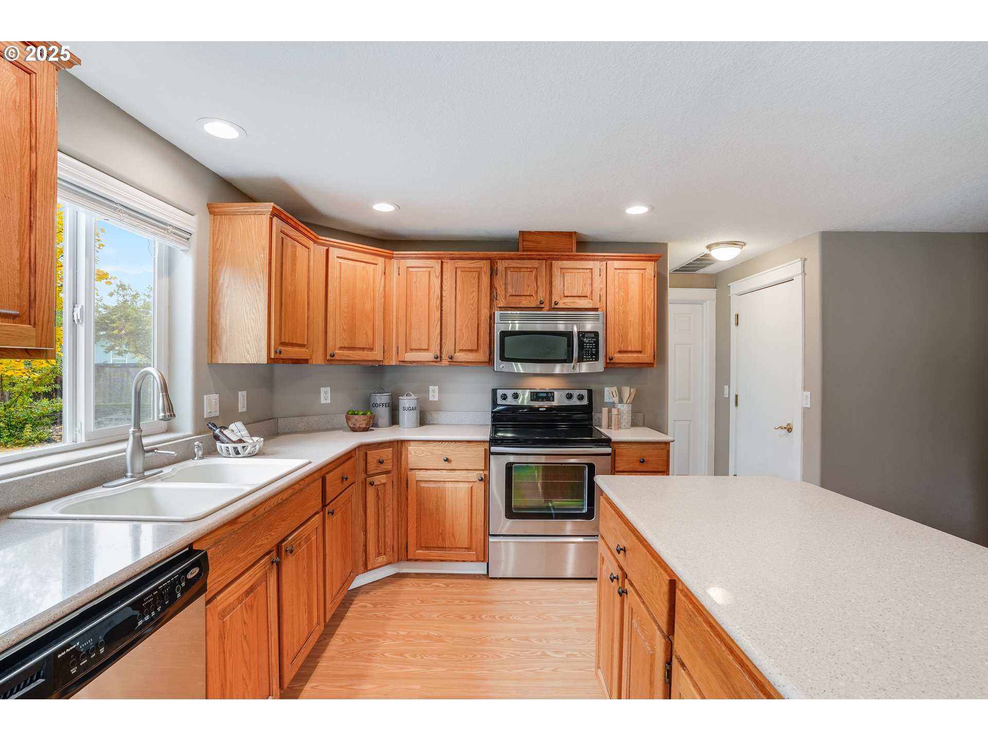 1224 Alyssum Avenue Forest Grove, OR 97116 - Photo 15 of 39 a kitchen with stainless steel appliances kitchen island granite countertop a sink stove refrigerator and cabinets