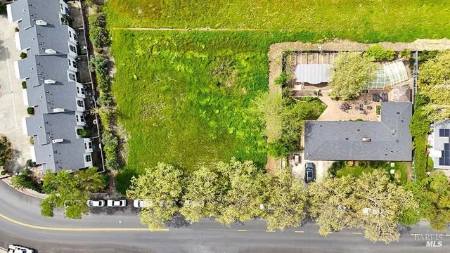 an aerial view of a house with a garden and plants