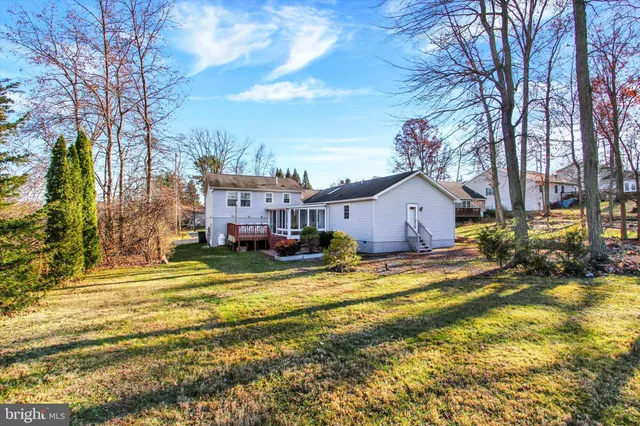 a view of a house with a big yard next to a house