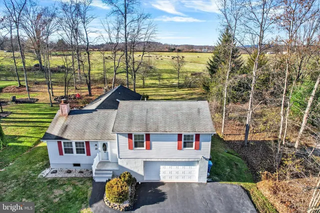 an aerial view of a house with a yard pool and outdoor seating
