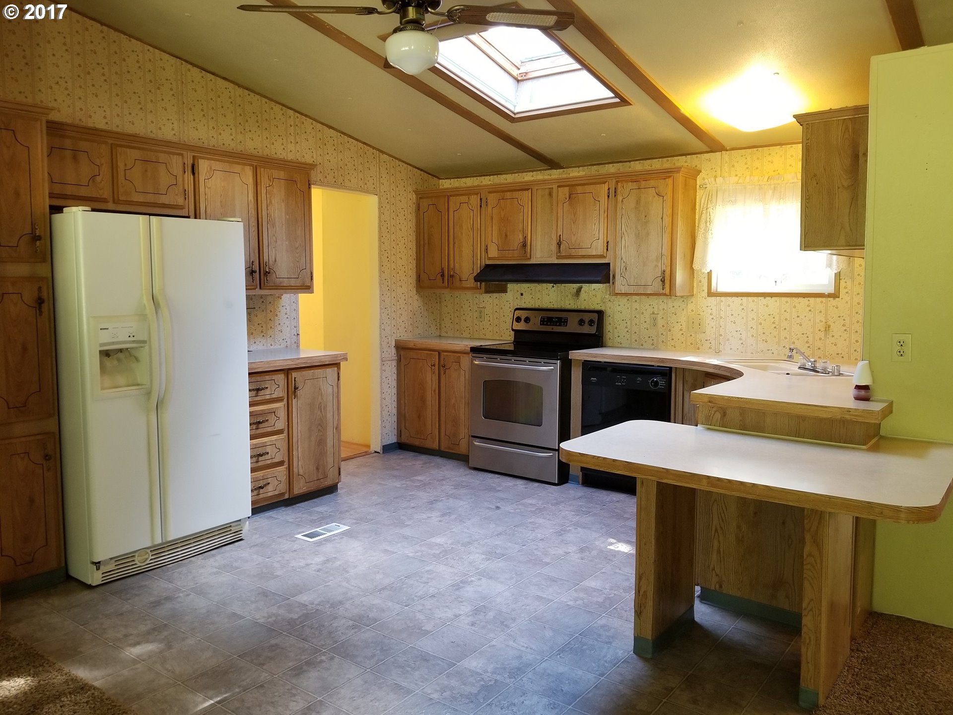 22960 Southwest Grand Ronde Road Grand Ronde, OR 97347 - Photo 8 of 25 a kitchen with stainless steel appliances a stove a sink refrigerator and a stove