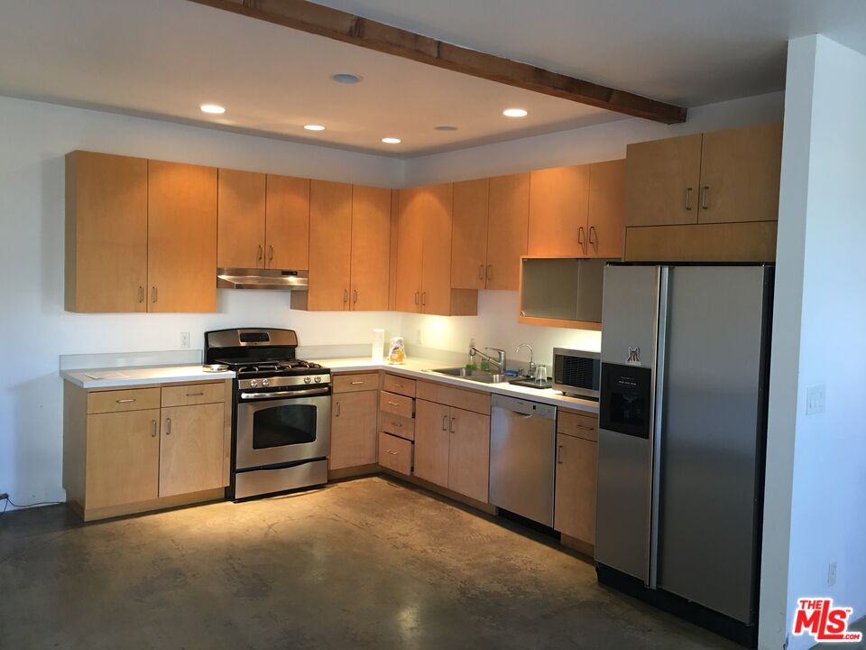 326 Indiana Avenue, Unit A Venice, CA 90291 - Photo 4 of 15 a kitchen with granite countertop stainless steel appliances and wooden cabinets