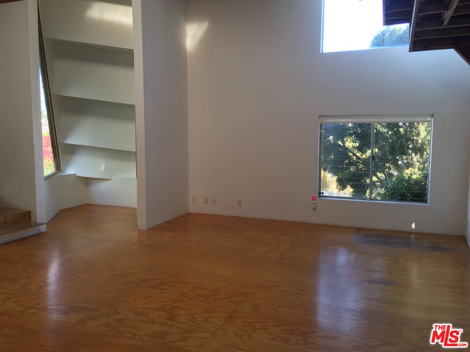 326 Indiana Avenue, Unit A Venice, CA 90291 - Photo 10 of 15 a view of an empty room with wooden floor and a window