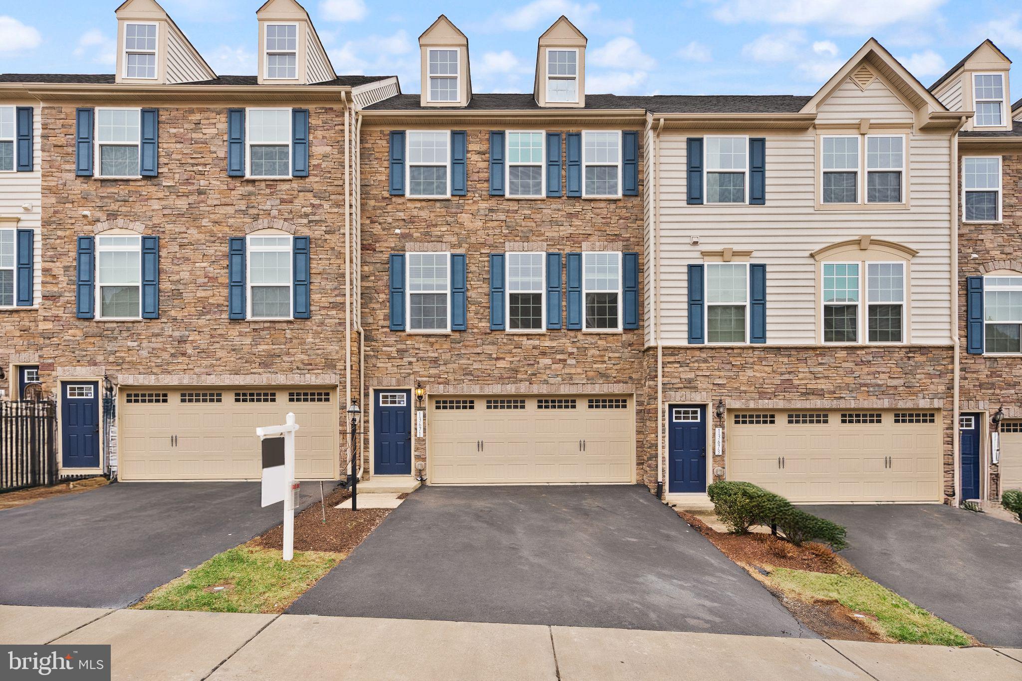 13671 Rockingham Lane Gainesville, VA 20155 - Photo 1 of 45 a front view of a house with a yard and garage