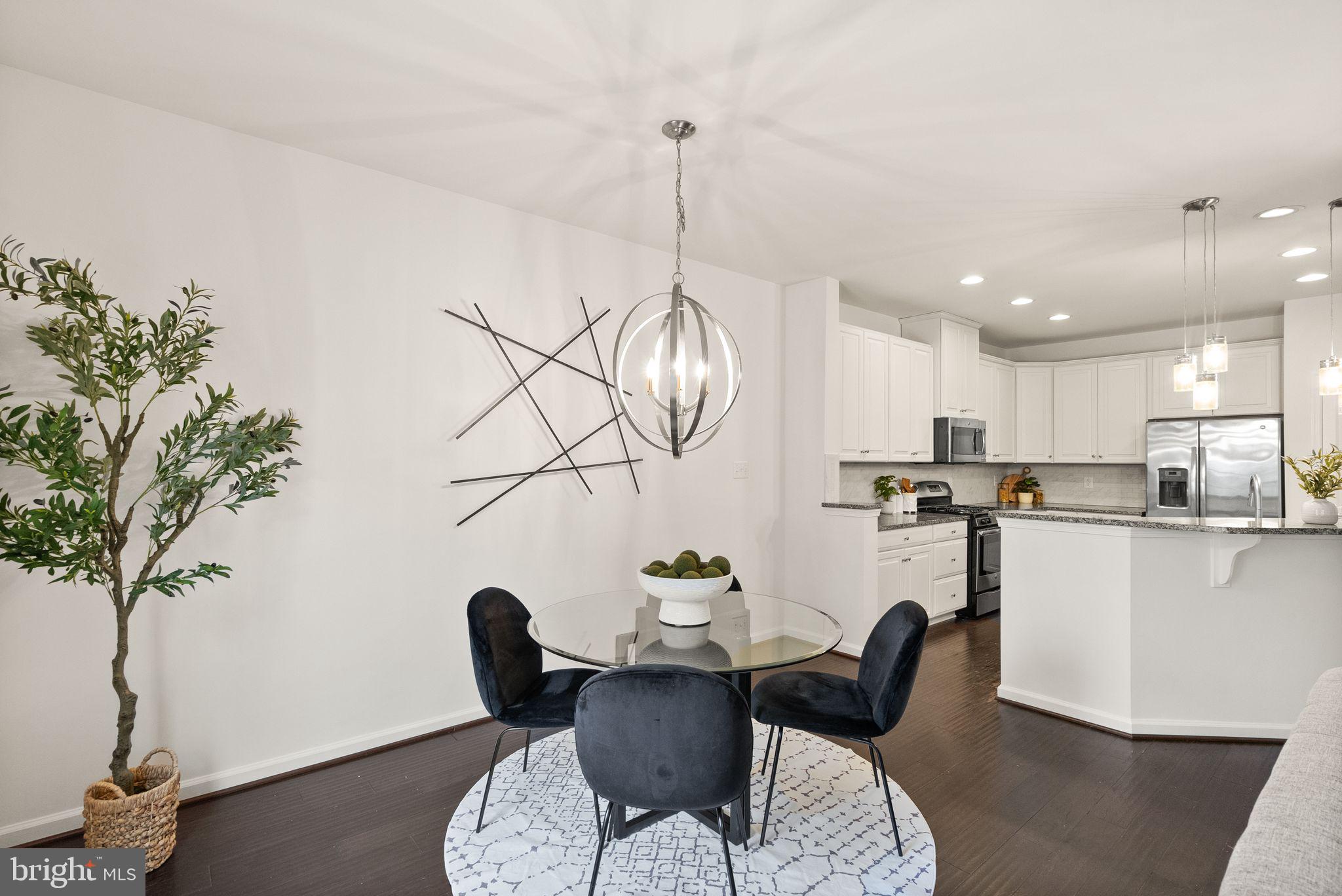 13671 Rockingham Lane Gainesville, VA 20155 - Photo 12 of 45 a view of a dining room with furniture window and wooden floor