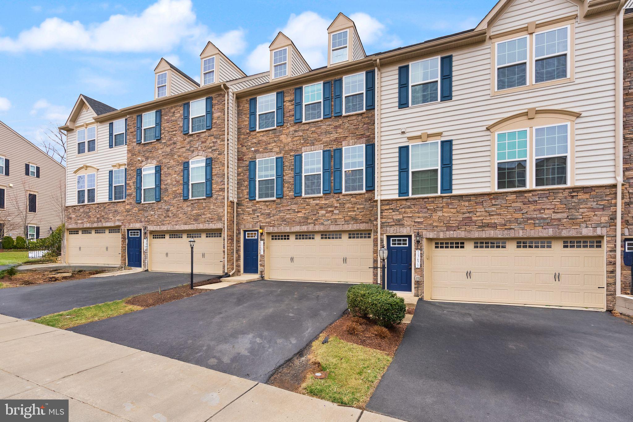 13671 Rockingham Lane Gainesville, VA 20155 - Photo 2 of 45 a front view of a building with a lot of windows