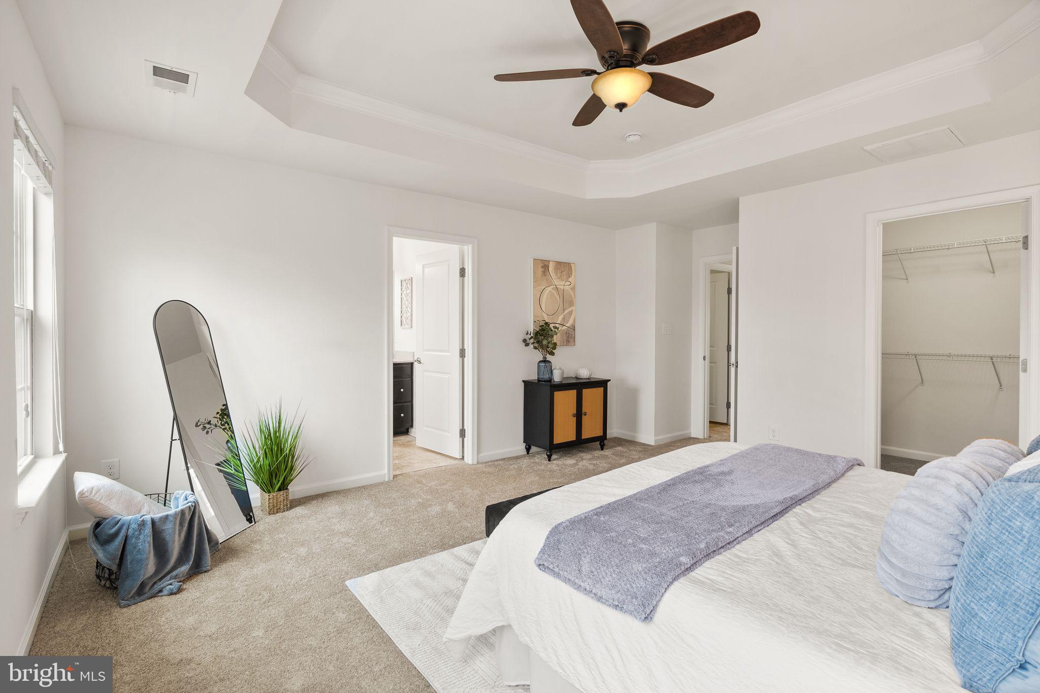 13671 Rockingham Lane Gainesville, VA 20155 - Photo 23 of 45 a bedroom with a bed dresser and a chandelier