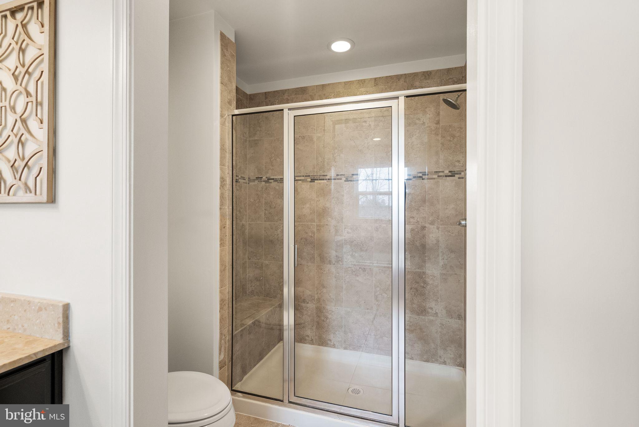 13671 Rockingham Lane Gainesville, VA 20155 - Photo 25 of 45 a bathroom with a glass shower door