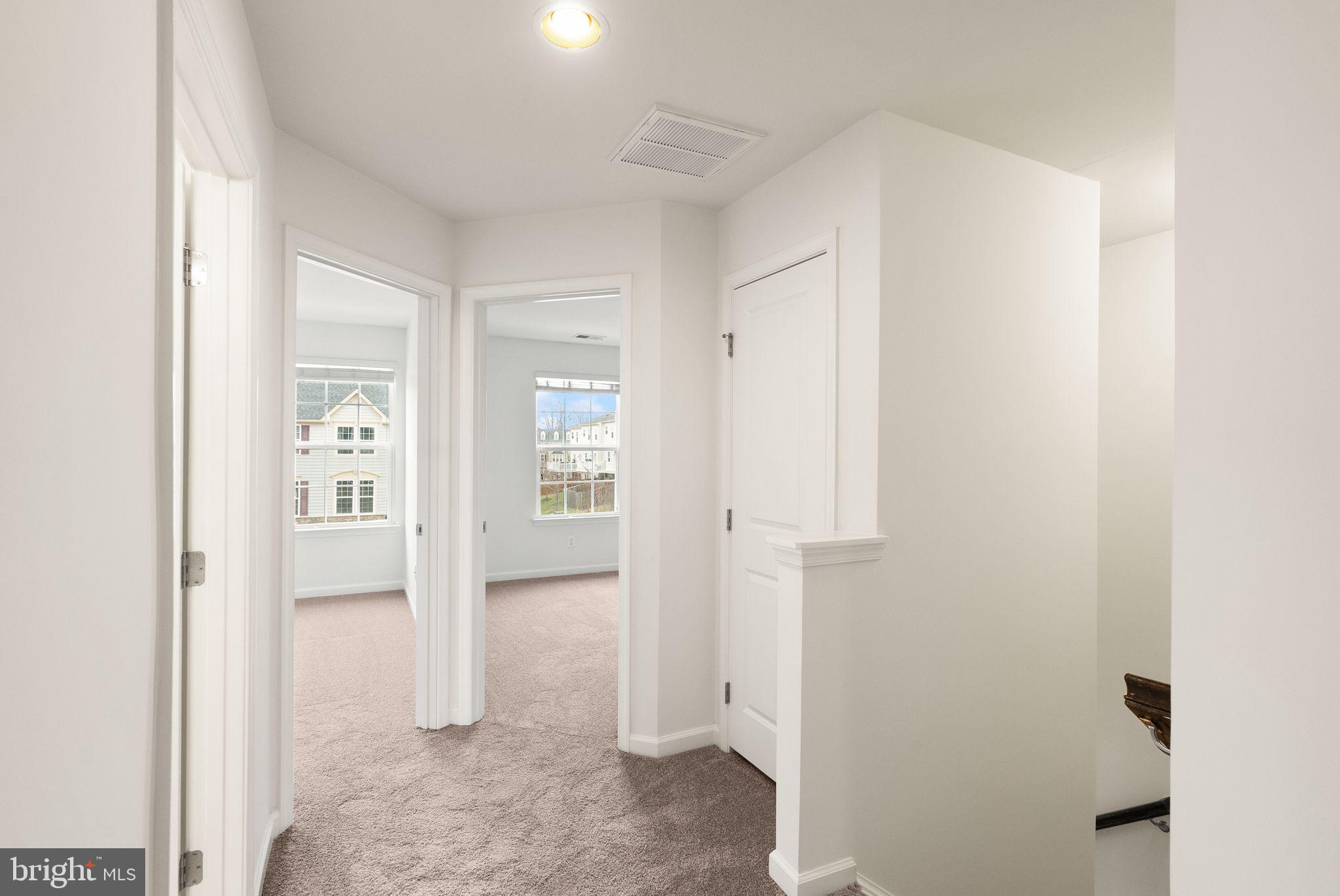 13671 Rockingham Lane Gainesville, VA 20155 - Photo 27 of 45 a view of a hallway with paintings on the wall