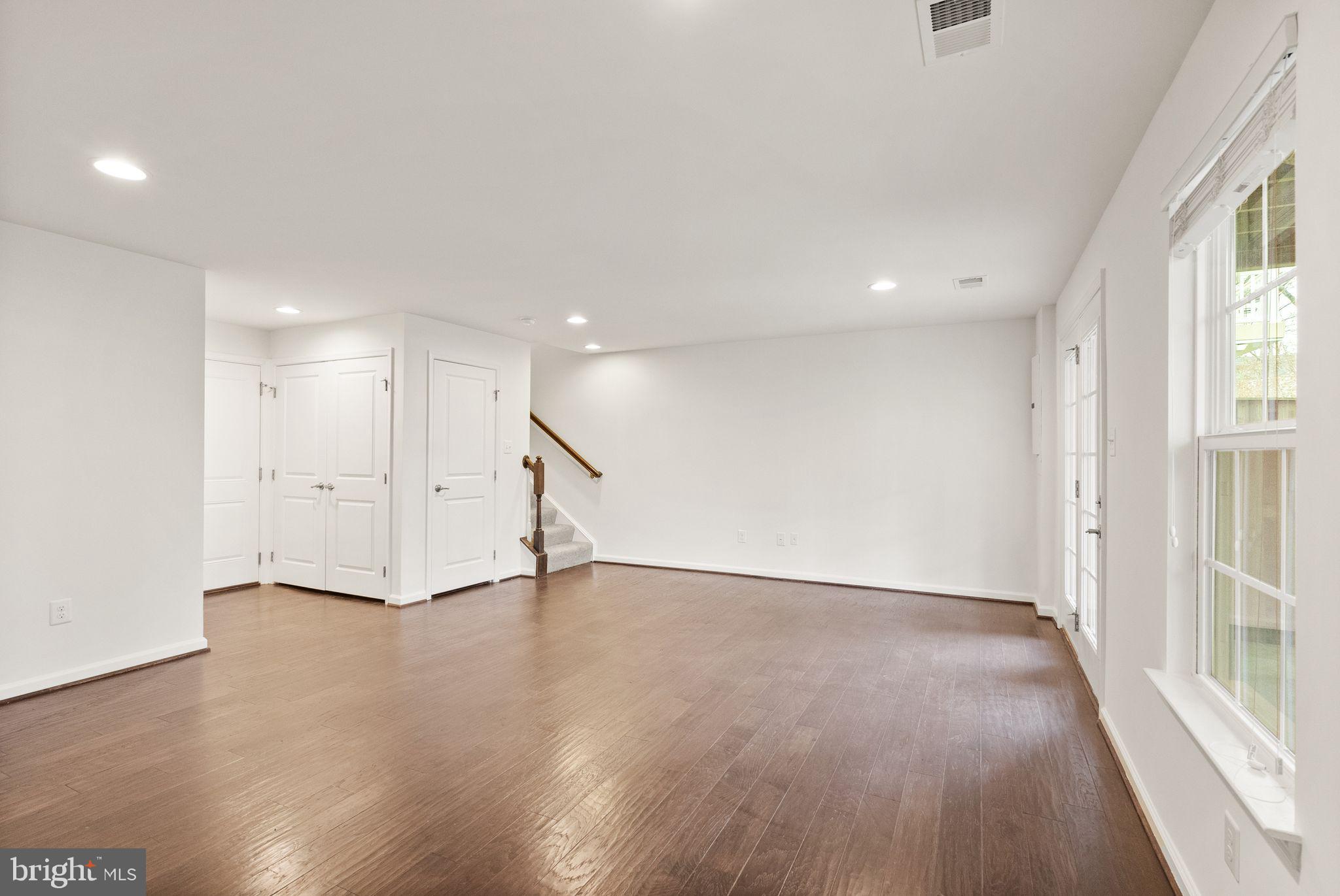 13671 Rockingham Lane Gainesville, VA 20155 - Photo 34 of 45 a view of an empty room with wooden floor and a window