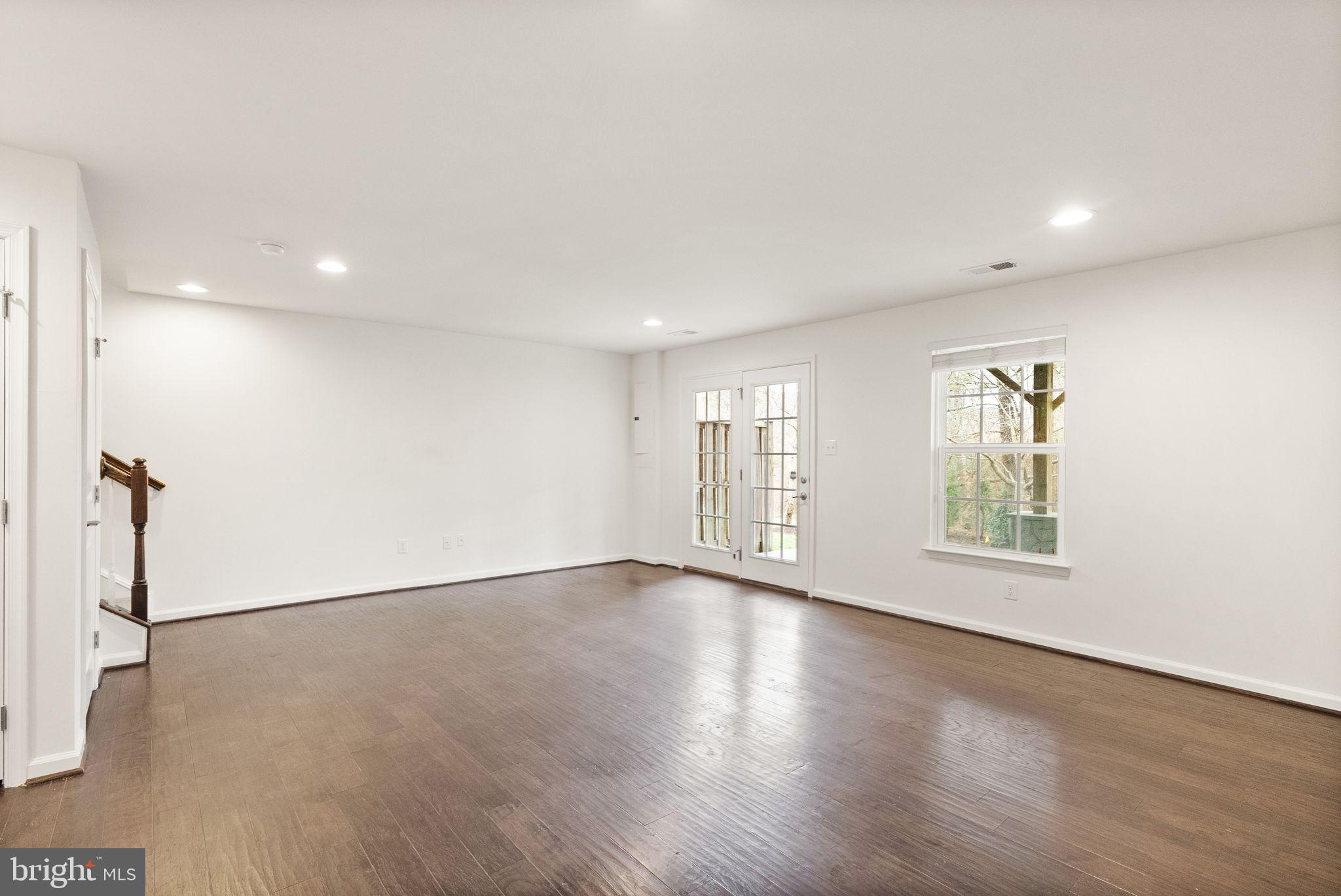 13671 Rockingham Lane Gainesville, VA 20155 - Photo 35 of 45 an empty room with wooden floor and windows