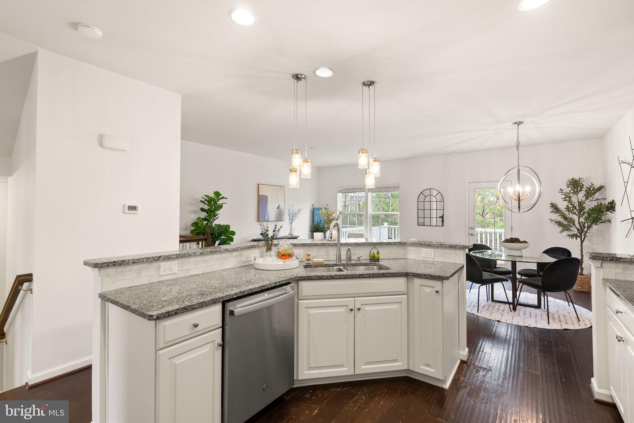 13671 Rockingham Lane Gainesville, VA 20155 - Photo 4 of 45 a kitchen with a sink cabinets and wooden floor