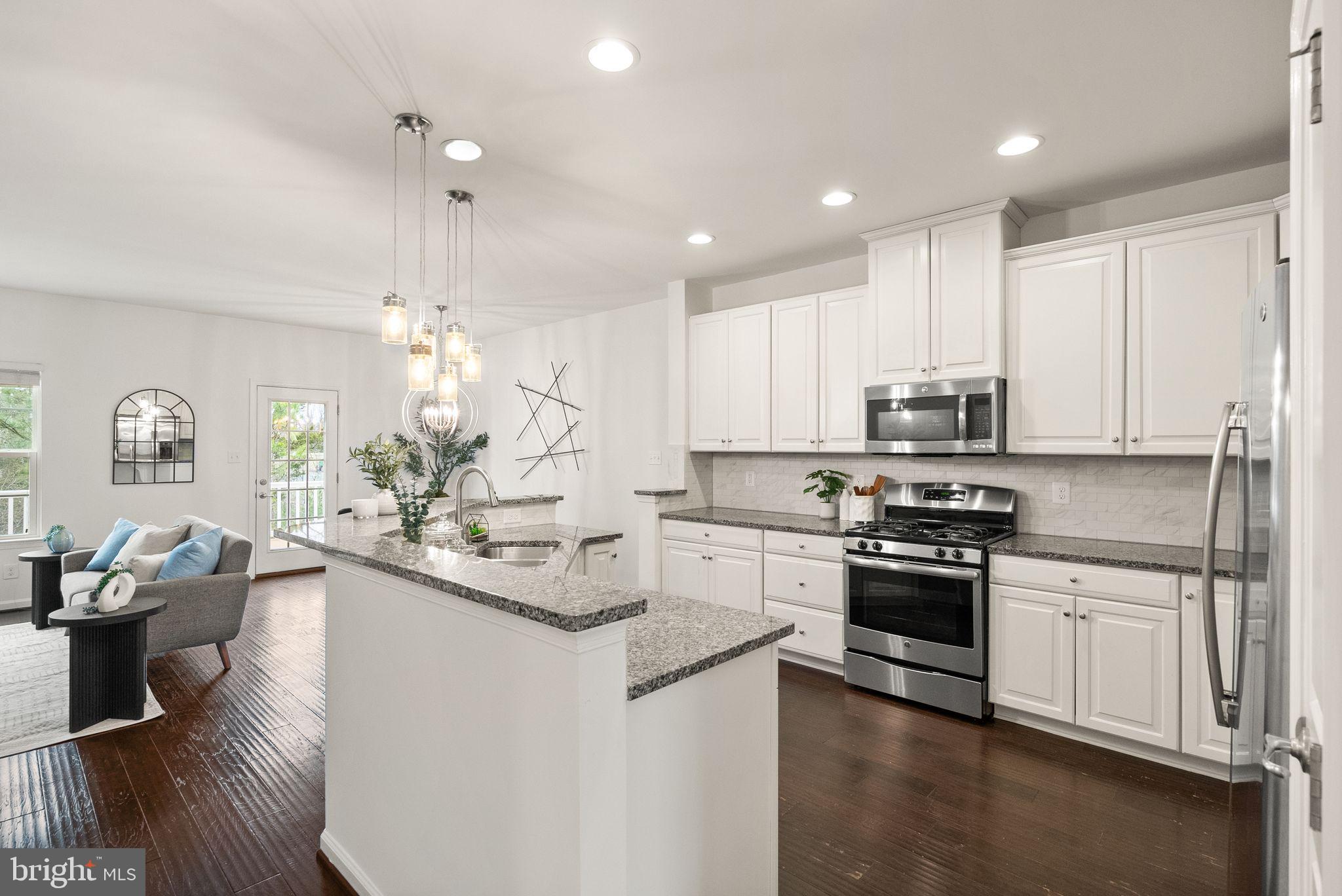13671 Rockingham Lane Gainesville, VA 20155 - Photo 5 of 45 a kitchen with stainless steel appliances granite countertop a sink stove and refrigerator