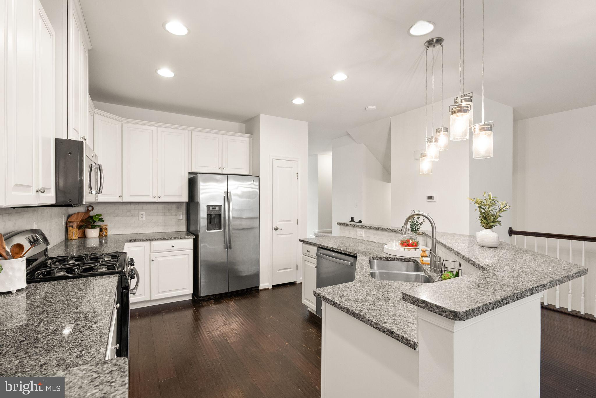 13671 Rockingham Lane Gainesville, VA 20155 - Photo 6 of 45 a kitchen with a refrigerator sink and stove