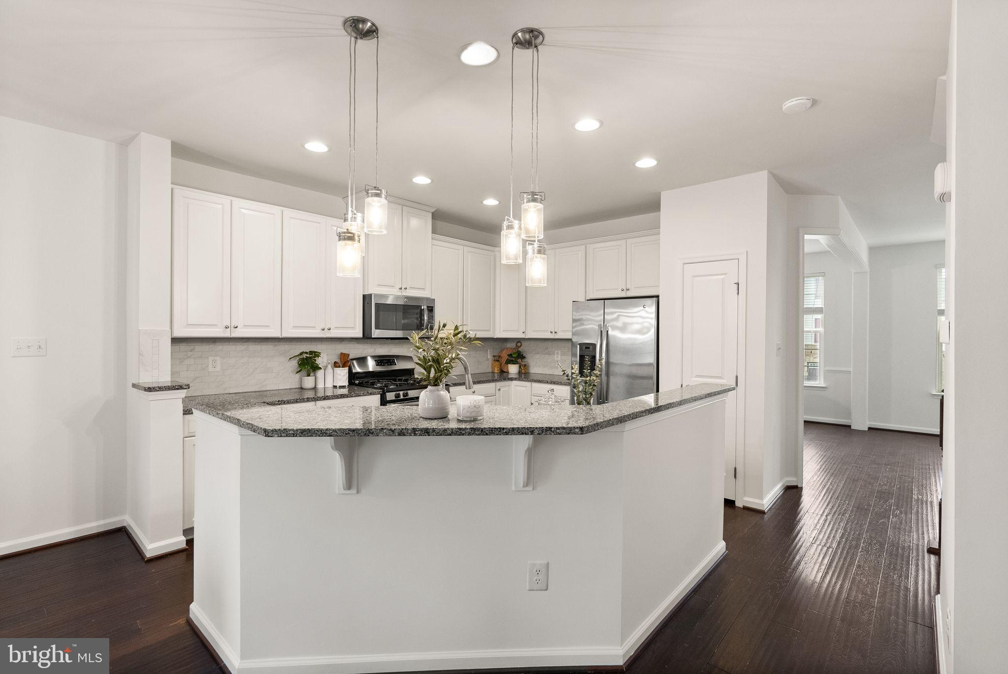 13671 Rockingham Lane Gainesville, VA 20155 - Photo 7 of 45 a kitchen with stainless steel appliances granite countertop a sink and a refrigerator