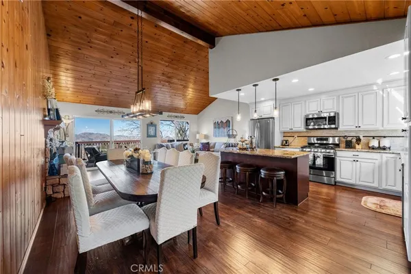 a kitchen with a dining table chairs and kitchen view