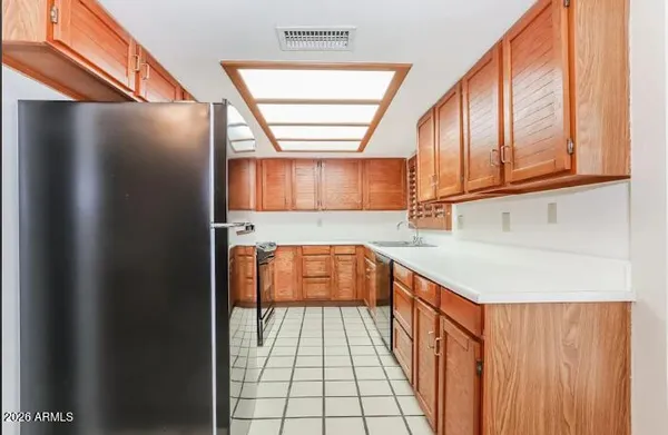 a kitchen with stainless steel appliances granite countertop a refrigerator and a stove