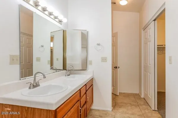 a bathroom with a double vanity sink and a mirror