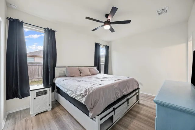 a bedroom with a bed and a large mirror