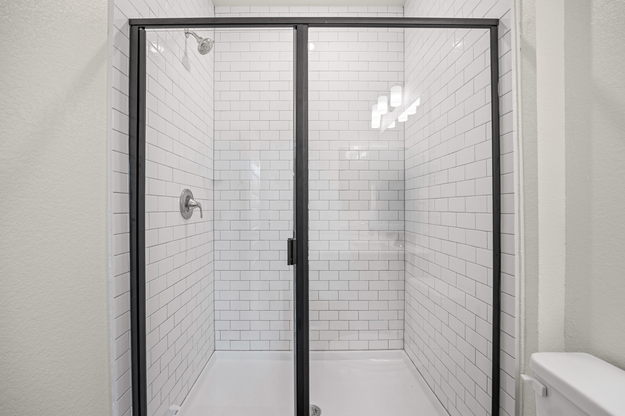 222 Summit Drive Lockhart, TX 78644 - Photo 16 of 31 a bathroom with a glass shower door