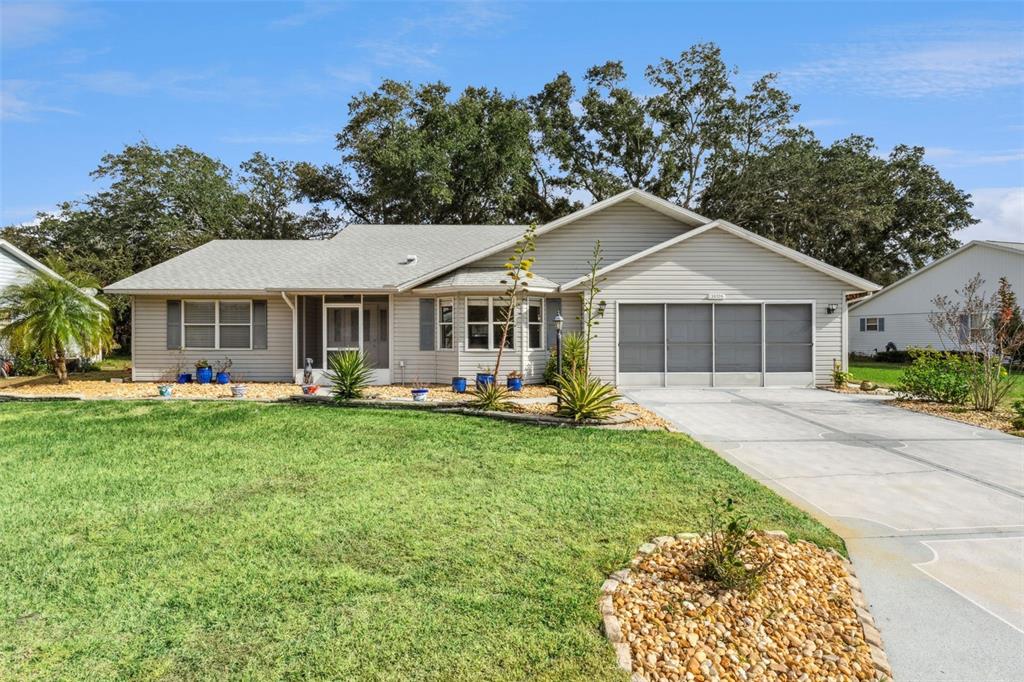 26126 Newcombe Circle Leesburg, FL 34748 - Photo 1 of 1 a front view of a house with garden