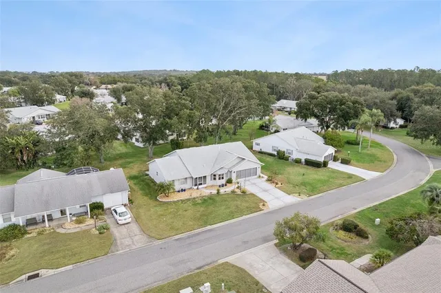 an aerial view of a house with a yard and lake view