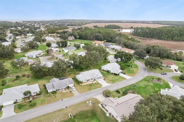 an aerial view of a house with a yard lake lake view and mountain view
