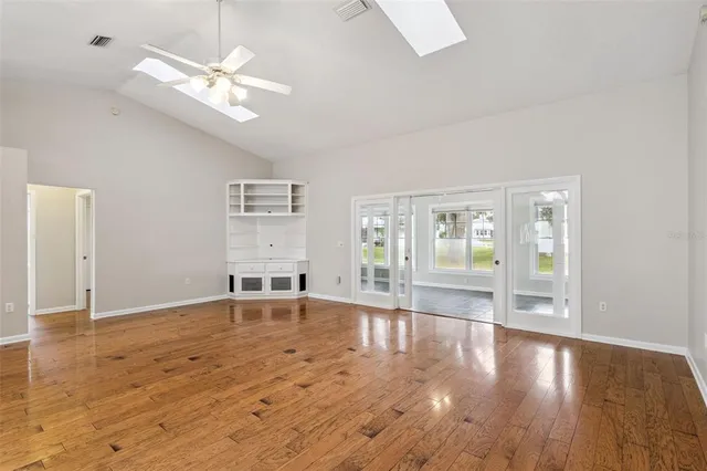 wooden floor in an empty room with a window