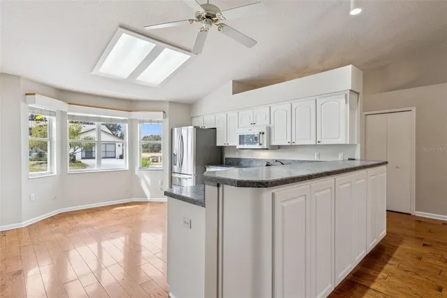 a kitchen with granite countertop stainless steel appliances and wooden cabinets