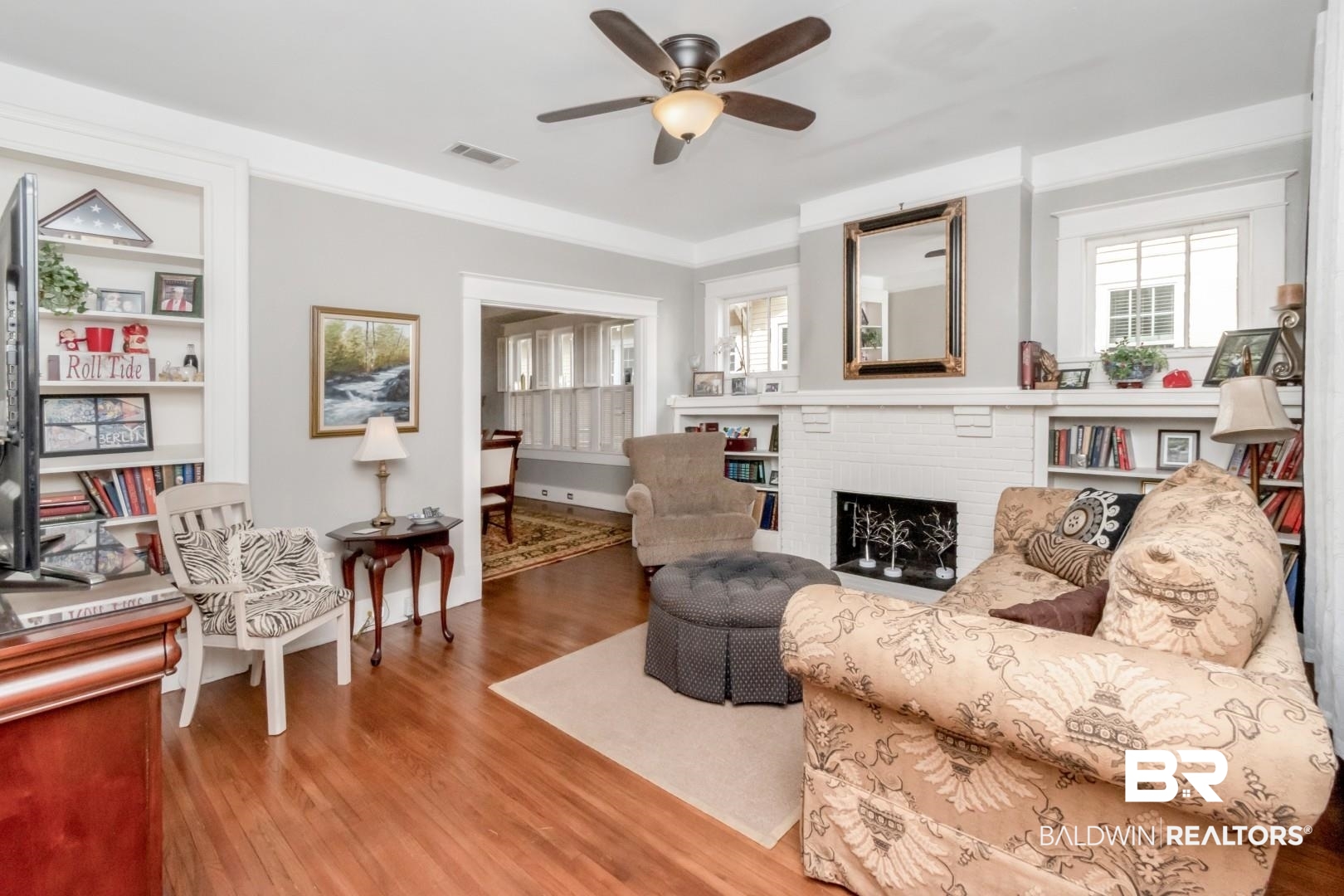 135 Silverwood Street Mobile, AL 36607 - Photo 3 of 32 Living room with wood finished floors, a fireplace, and a ceiling fan