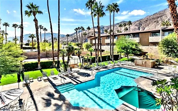 a view of swimming pool with outdoor seating and plants