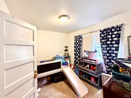 a backyard of a house with table and chairs