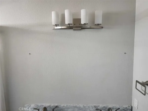 a view of kitchen with white wall and sink