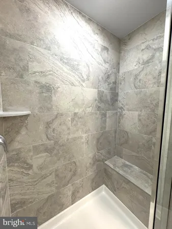 a bathroom with a double vanity sink toilet and shower