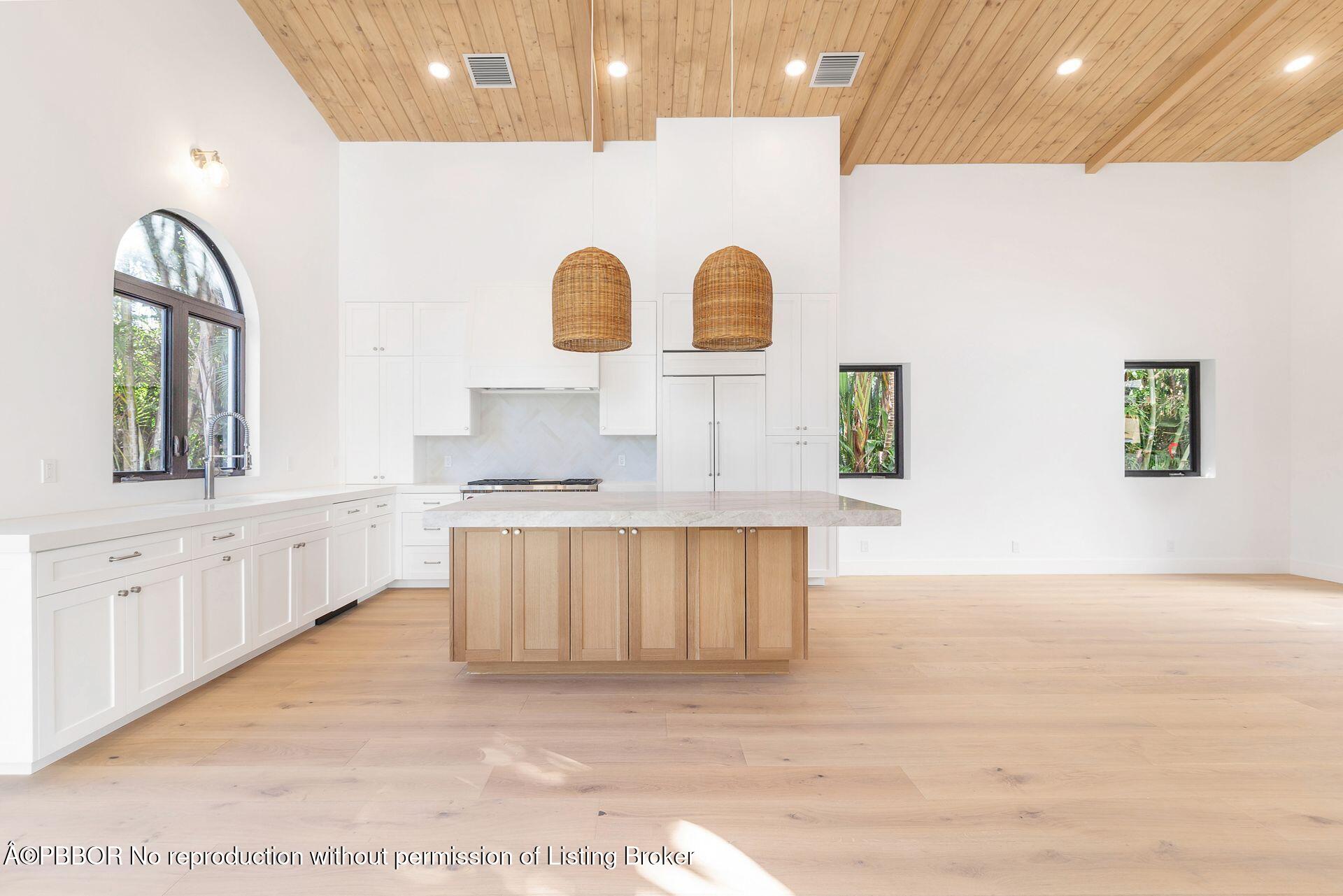 320 Plymouth Road West Palm Beach, FL 33405 - Photo 11 of 39 a large white kitchen with kitchen island a sink stainless steel appliances and cabinets