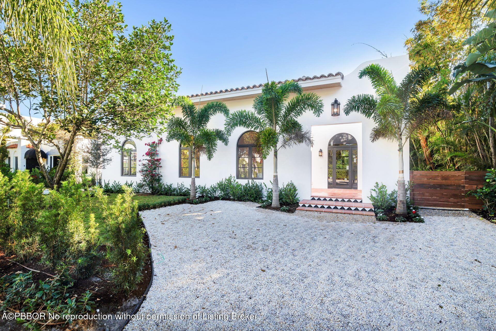 320 Plymouth Road West Palm Beach, FL 33405 - Photo 33 of 39 a view of a white house with a yard and potted plants