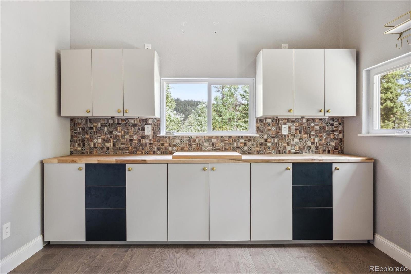 3450 Smith Hill Road Black Hawk, CO 80422 - Photo 14 of 26 a kitchen with stainless steel appliances white cabinets and a window